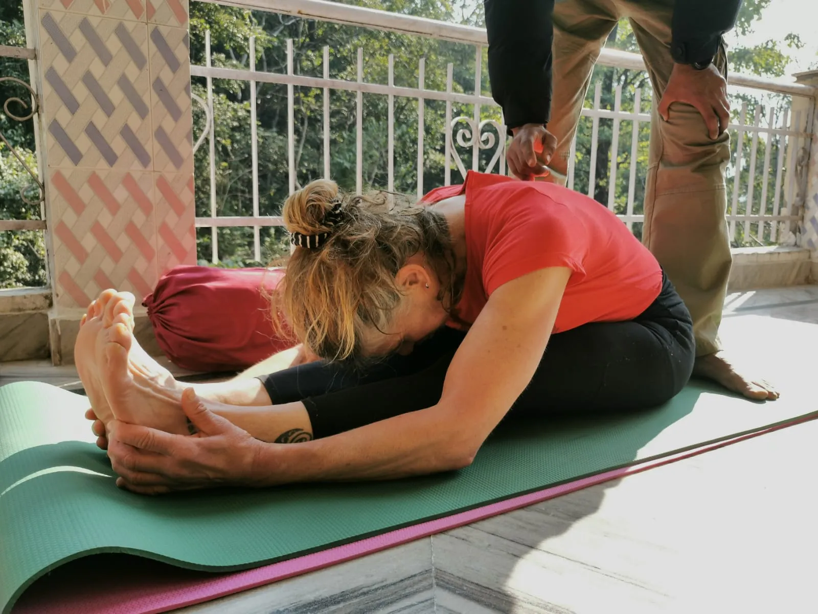 Yoga students performing partner poses as part of their daily training routine at Jiva Yoga Academy.