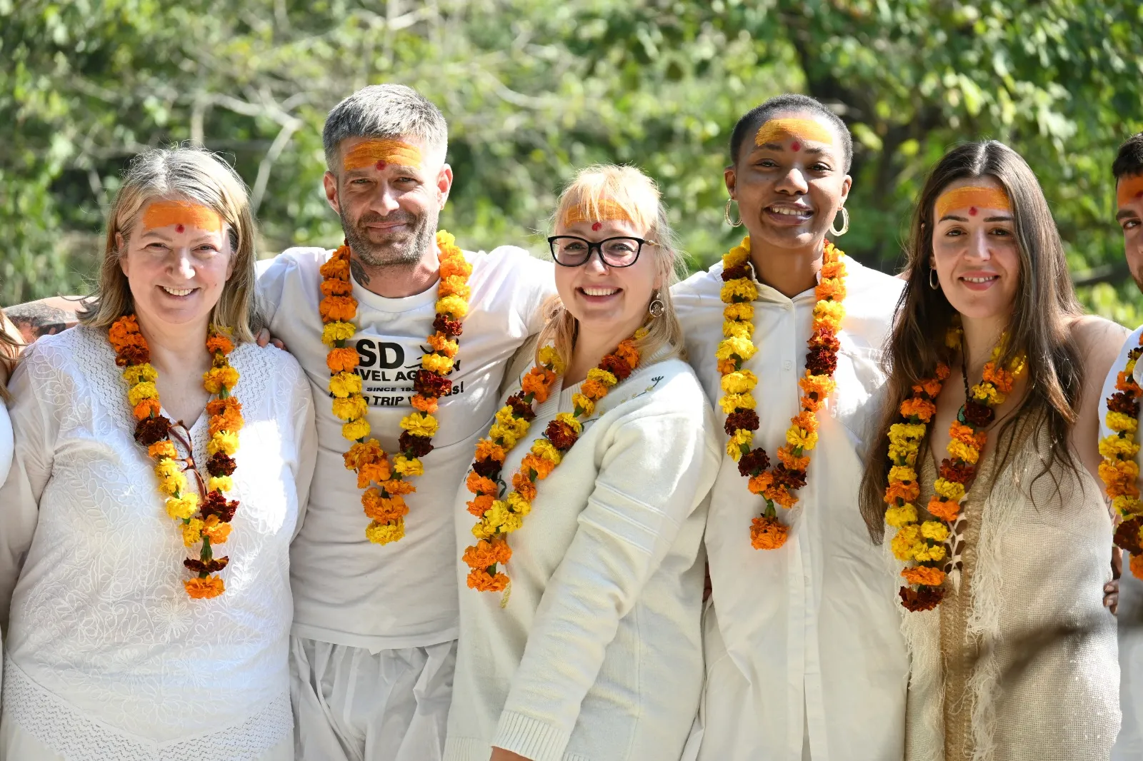 Yoga students celebrating their success with garlands at Jiva Yoga Academy