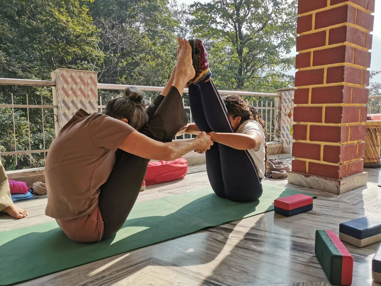 yoga students practicing advanced asanas during their daily schedule at Jiva Yoga Academy, Rishikesh